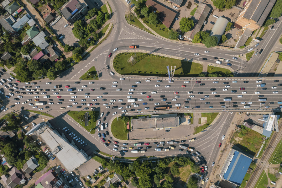 Aerial view vehicular intersection traffic peak hour with cars road